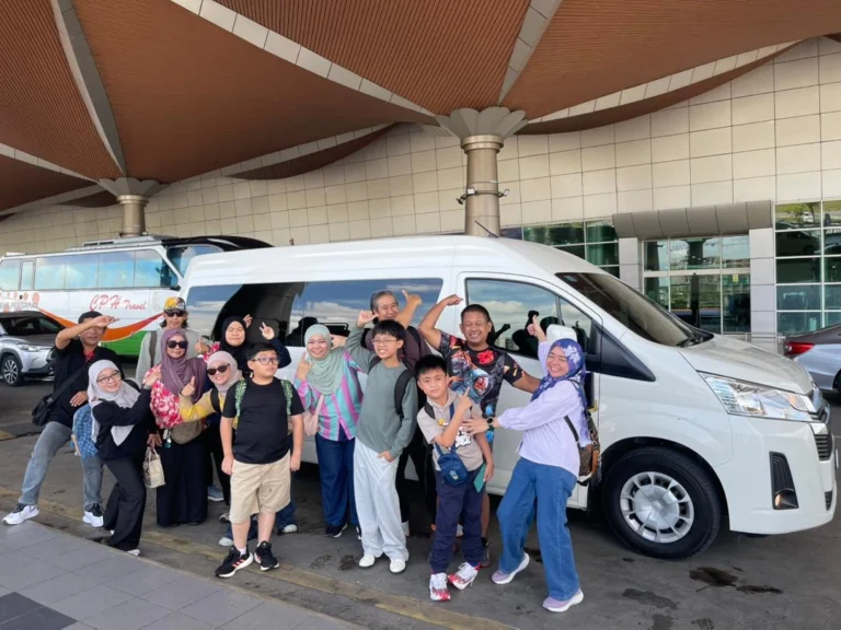 Large group of tourists arriving at Kuching Airport for airport pickup car rental services.